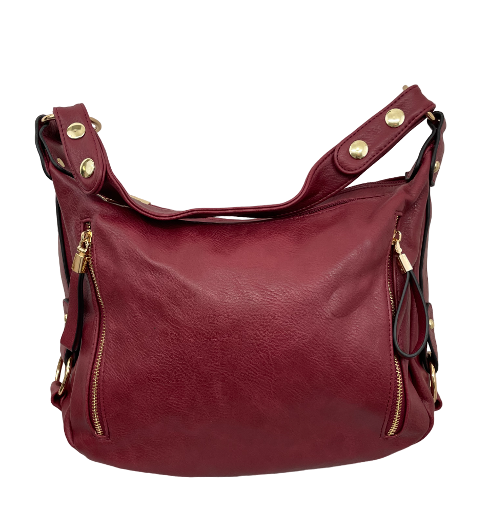 Handbag with decorative side strips, rings and studs